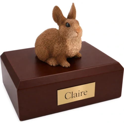 Memorial cremation urn with brown and white rabbit figurine, walnut finish